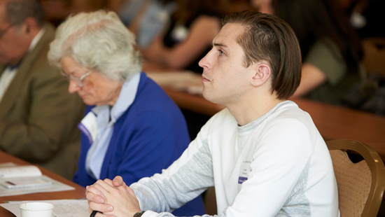 Two audience members listening